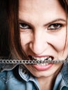 Angry woman mad girl biting metal chain Royalty Free Stock Photo