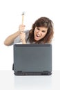 Angry woman ready to destroy a computer with a hammer Royalty Free Stock Photo