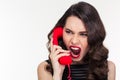 Angry woman in retro style screaming and talking on telephone Royalty Free Stock Photo