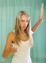 Angry woman with rolling-pin in hand