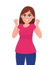 Angry woman is screaming and raising her fists up. Furious angry woman screaming with rage and frustration. Human emotion concept. Royalty Free Stock Photo