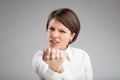 Angry woman shaking her fist at the camera