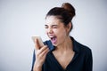 Angry woman shouting on phone on gray background Royalty Free Stock Photo