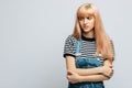 Angry woman in striped t-shirt frowning her face in displeasure, keeping arms folded, looking away. Skepticism Royalty Free Stock Photo