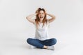 Angry woman in t-shirt sitting on the floor and screaming Royalty Free Stock Photo