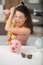 angry woman trying to break piggy bank Royalty Free Stock Photo