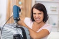 angry woman using drill to open locked suitcase