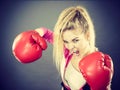 Angry woman wearing boxing gloves