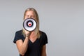 Angry woman yelling into a handheld megaphone Royalty Free Stock Photo