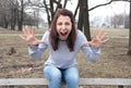 Angry woman yelling with hands up