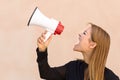Angry woman yelling into a megaphone Royalty Free Stock Photo