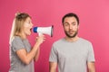 angry woman yelling with megaphone at man, isolated Royalty Free Stock Photo