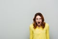 angry woman in yellow blouse screaming