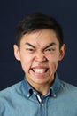 Angry young Asian man making face Royalty Free Stock Photo