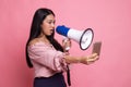 Angry young Asian woman  shout with megaphone to mobile phone Royalty Free Stock Photo