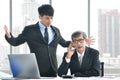 Angry young boss yelling at senior employee, business concept, Asian businessman Royalty Free Stock Photo