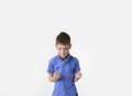 Angry young boy with fists clenched isolated on white Royalty Free Stock Photo