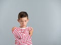 Angry young boy isolated on gray background Royalty Free Stock Photo