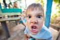 Angry young boy making grimace and expressing aggression Royalty Free Stock Photo