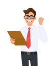 Angry young business man holding clipboard and showing raised arm sign. Aggressive person carrying document or record. Enraged. Royalty Free Stock Photo