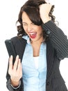 Angry Young Business Woman Screaming Down a Telephone Royalty Free Stock Photo