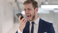 Angry Young Businessman Answering Phone Call Royalty Free Stock Photo