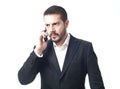 Angry young businessman on the phone. Royalty Free Stock Photo