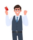 Angry young businessman showing credit, debit card. Man making or gesturing raised hand fist. Frustrated/stressed person. Royalty Free Stock Photo