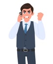 Angry young businessman in waistcoat speaking on phone and gesturing raised hand fist. Frustrated, aggressive person calling Royalty Free Stock Photo