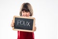 Angry young child rejecting head lice from a school slate Royalty Free Stock Photo