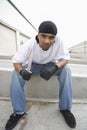 Angry Young Criminal Sitting With Knife On Terrace