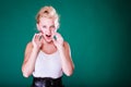 Angry young girl screaming, hands close to mouth