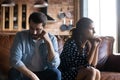 Angry young husband and wife sitting together, hating, ignoring