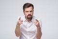 Angry young man with beard accusing you, pointing finger at you. You are guilty. Royalty Free Stock Photo