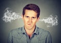 Angry young man, blowing steam coming out of ears Royalty Free Stock Photo