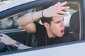 Angry Young Man Driving a Car and Yelling at People Royalty Free Stock Photo