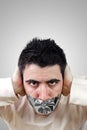 Angry young man having gray duct tape on his mouth Royalty Free Stock Photo