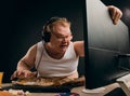 Angry young man in headset playing game at home