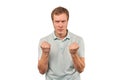 Furious young man in mint T-shirt ready to fight with fists isolated on white background Royalty Free Stock Photo