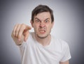 Angry young man is pointing towards you Royalty Free Stock Photo