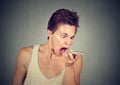 Angry young man screaming on mobile phone Royalty Free Stock Photo