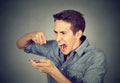 Angry young man screaming on mobile phone Royalty Free Stock Photo