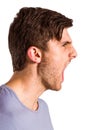 Angry young man with stubble shouting