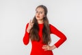 Angry young woman arguing shake index finger, punishing mischief, standing against white studio background. Girl looking