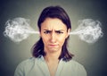 Angry young woman, blowing steam coming out of ears Royalty Free Stock Photo