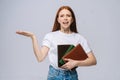 Angry young woman college student holding book and screaming crying looking at camera Royalty Free Stock Photo