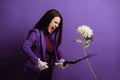 Angry young woman cutting chrysanthemum with