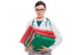 Angry young woman doctor with stethoscope holding binders in her hands in white uniform on white background Royalty Free Stock Photo