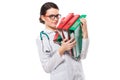 Angry young woman doctor with stethoscope holding binders in her hands in white uniform on white background Royalty Free Stock Photo