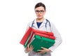 Angry young woman doctor with stethoscope holding binders in her hands in white uniform on white background Royalty Free Stock Photo